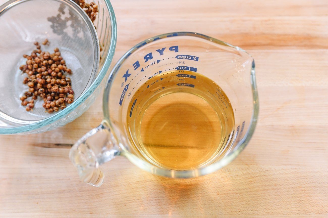 strained Sichuan peppercorn infused liquid in measuring cup