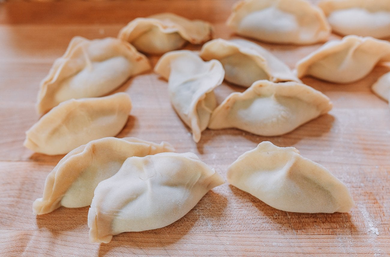 handmade dumplings on wooden cutting board