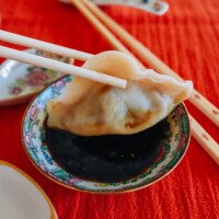 dipping beef dumpling into Chinese black vinegar