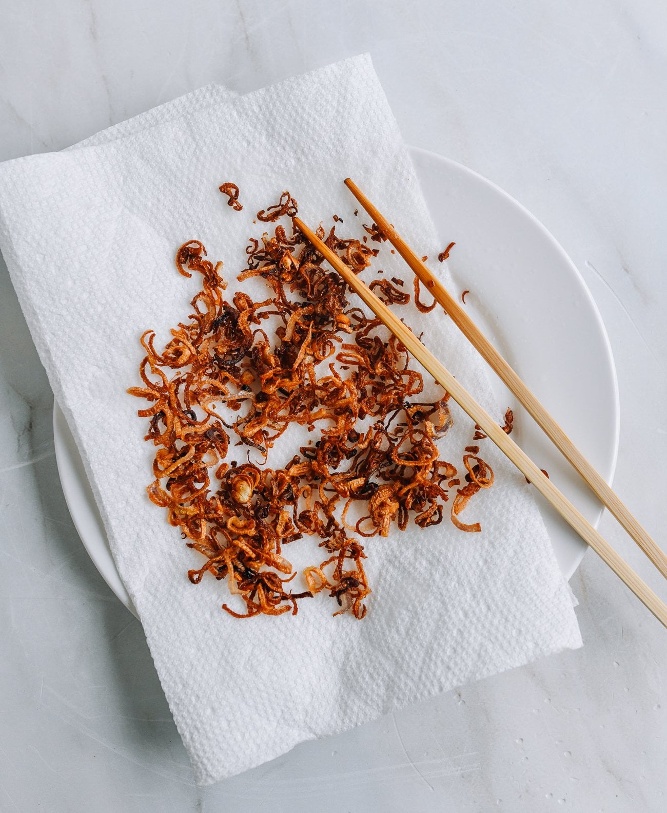 fried shallots on paper towel lined plate