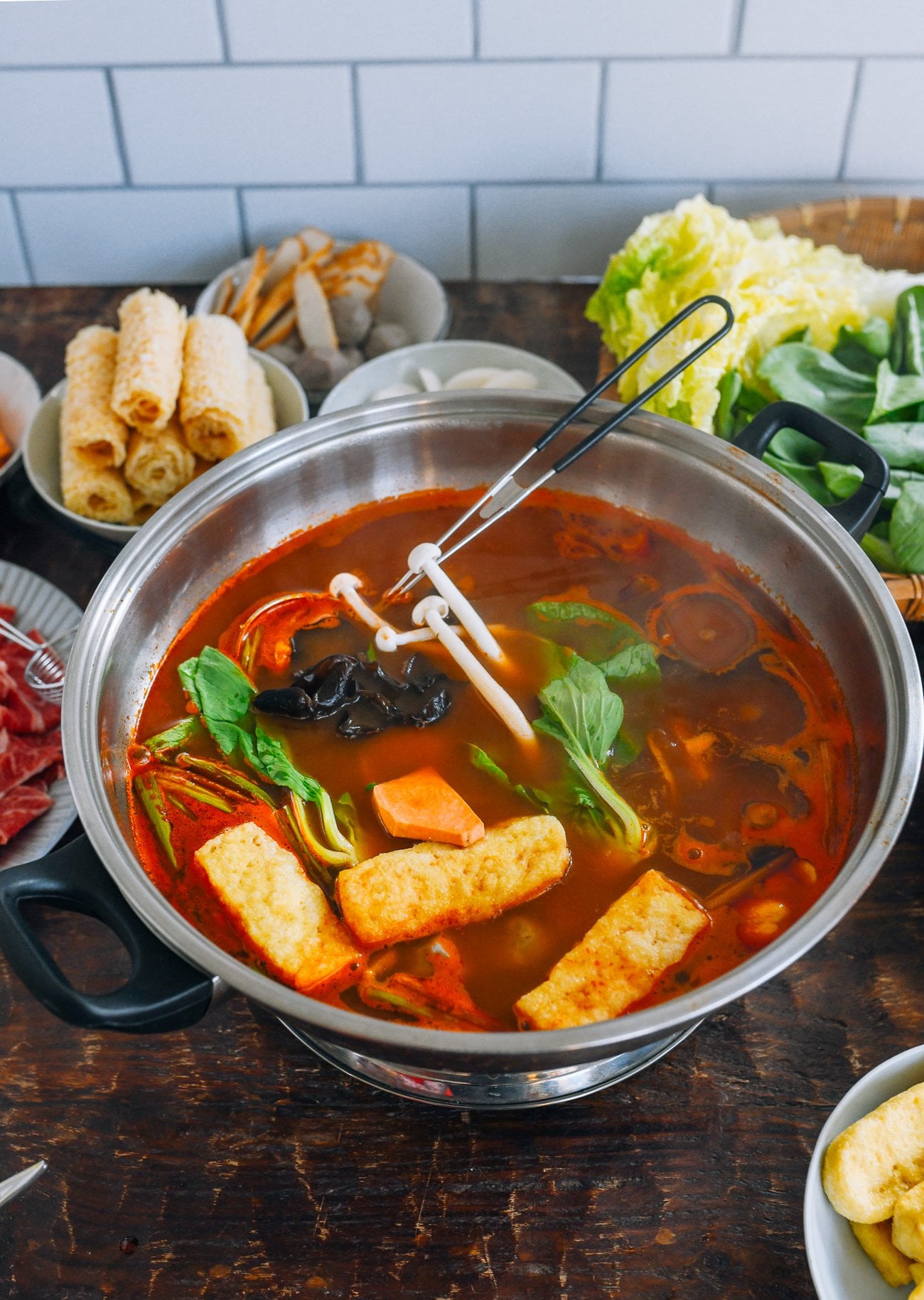 putting ingredients into tomato hot pot base