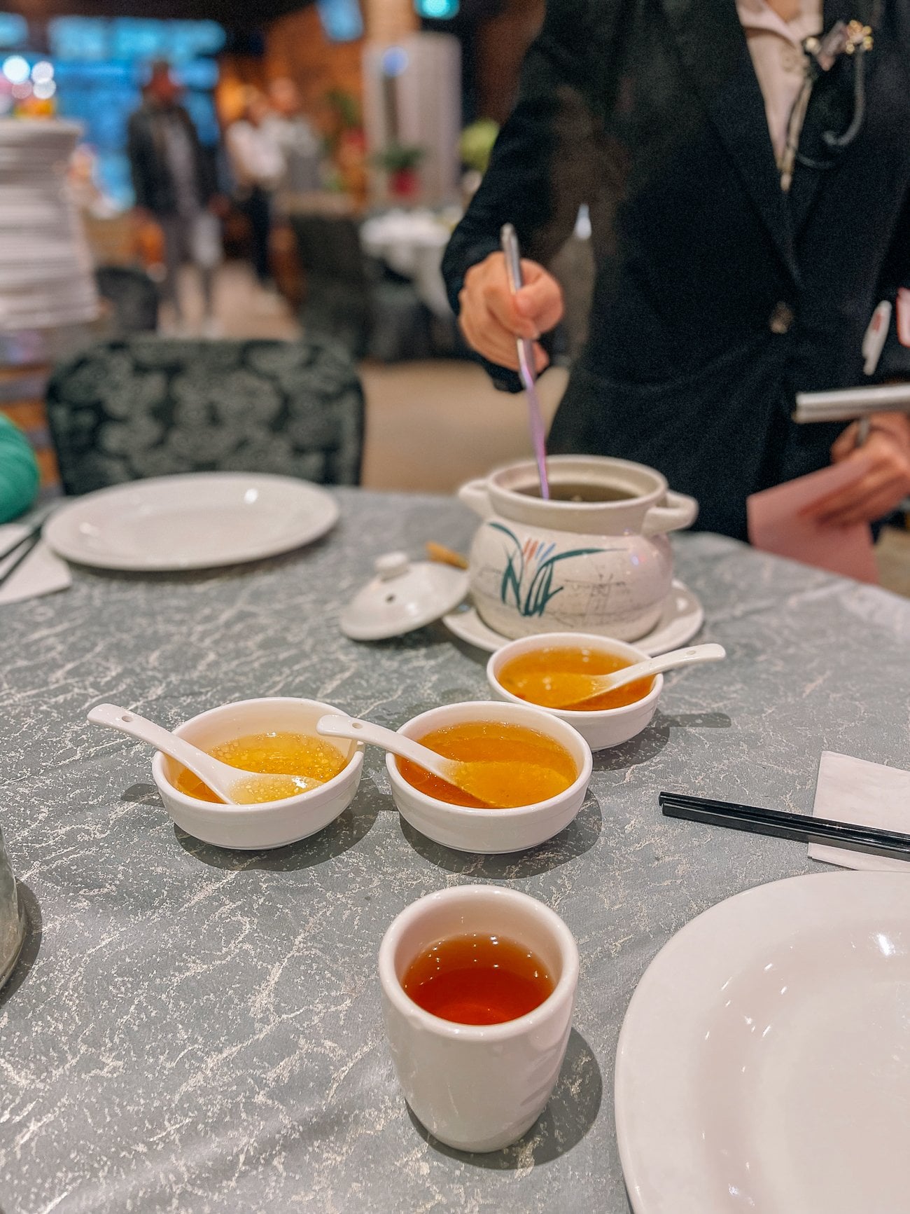 Ladling Chicken and pork soup at Chinese Restaurant