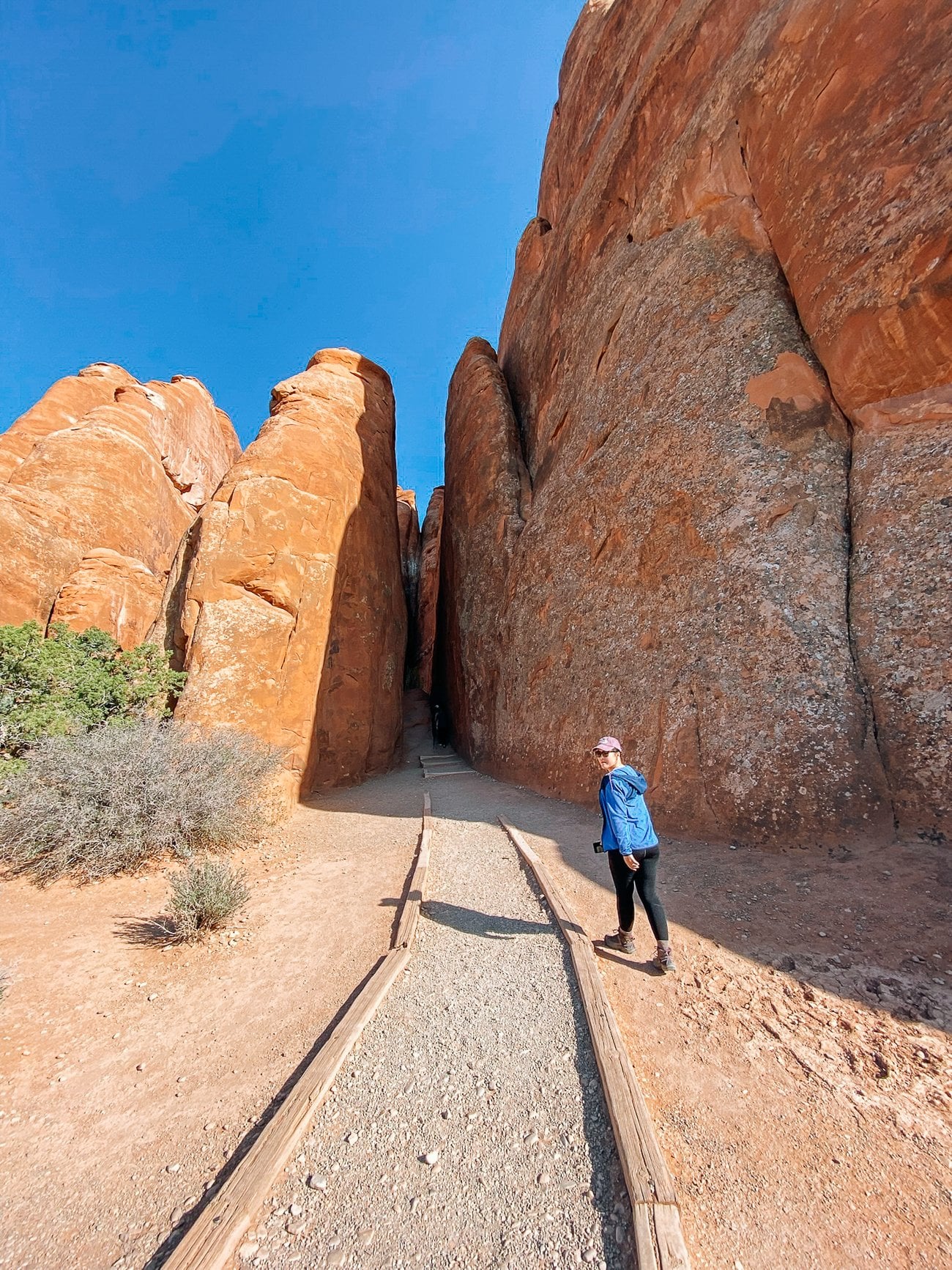 Sarah walking into Sand Dune Arch Trailhead