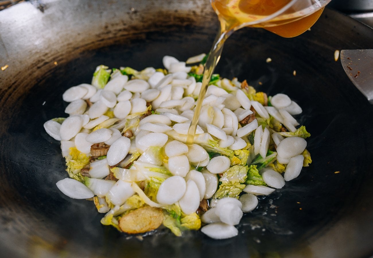 adding stock to rice cakes
