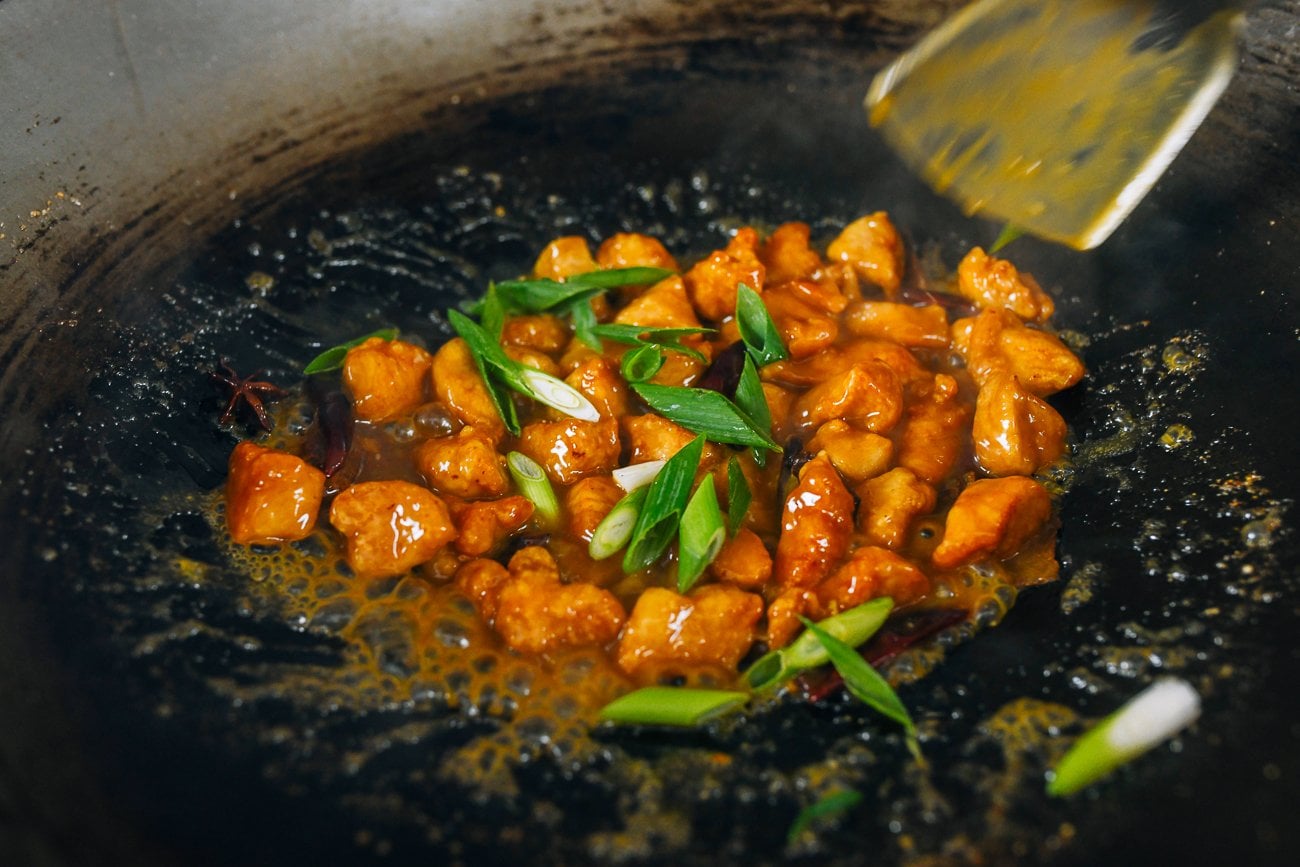 orange chicken in wok with scallions