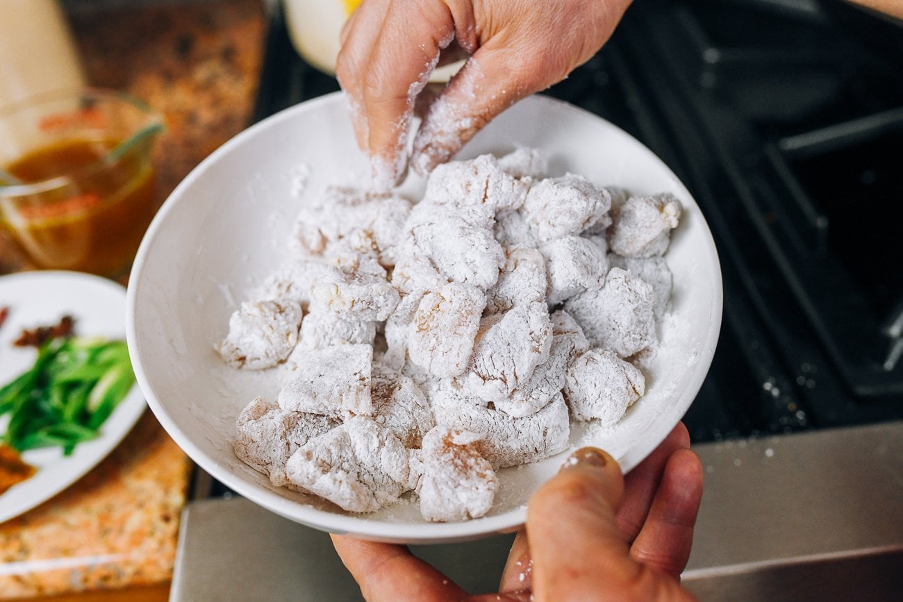 dredging chicken pieces in cornstarch