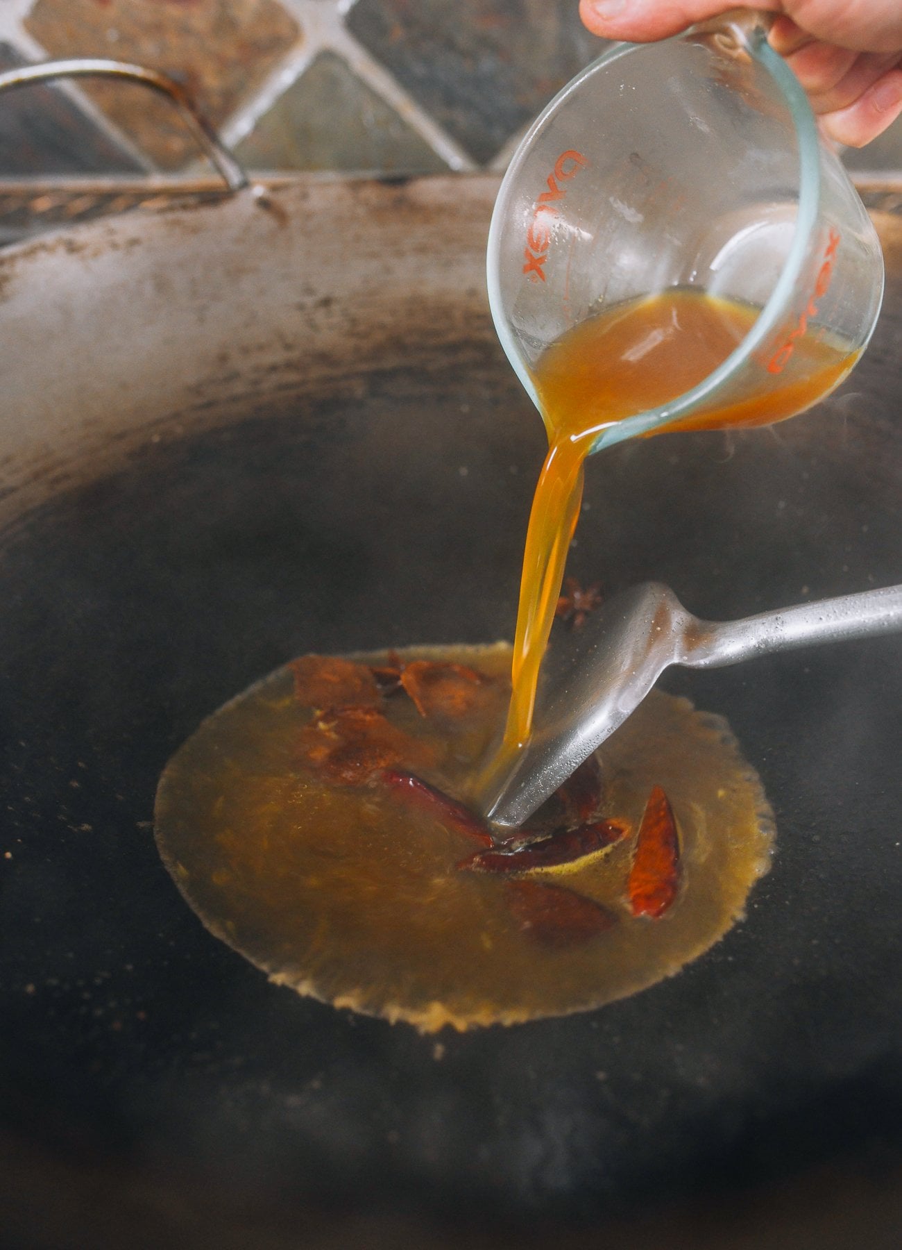 adding sauce mixture to wok