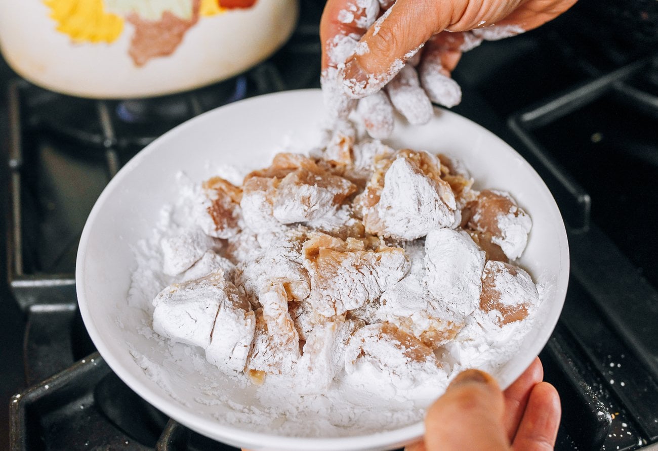 dredging chicken pieces in cornstarch