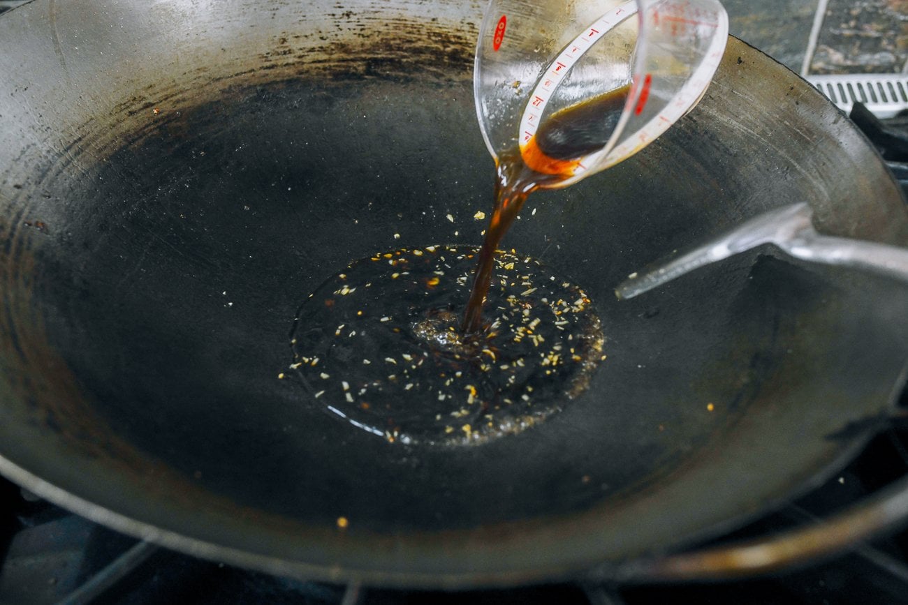 adding sauce mixture to wok