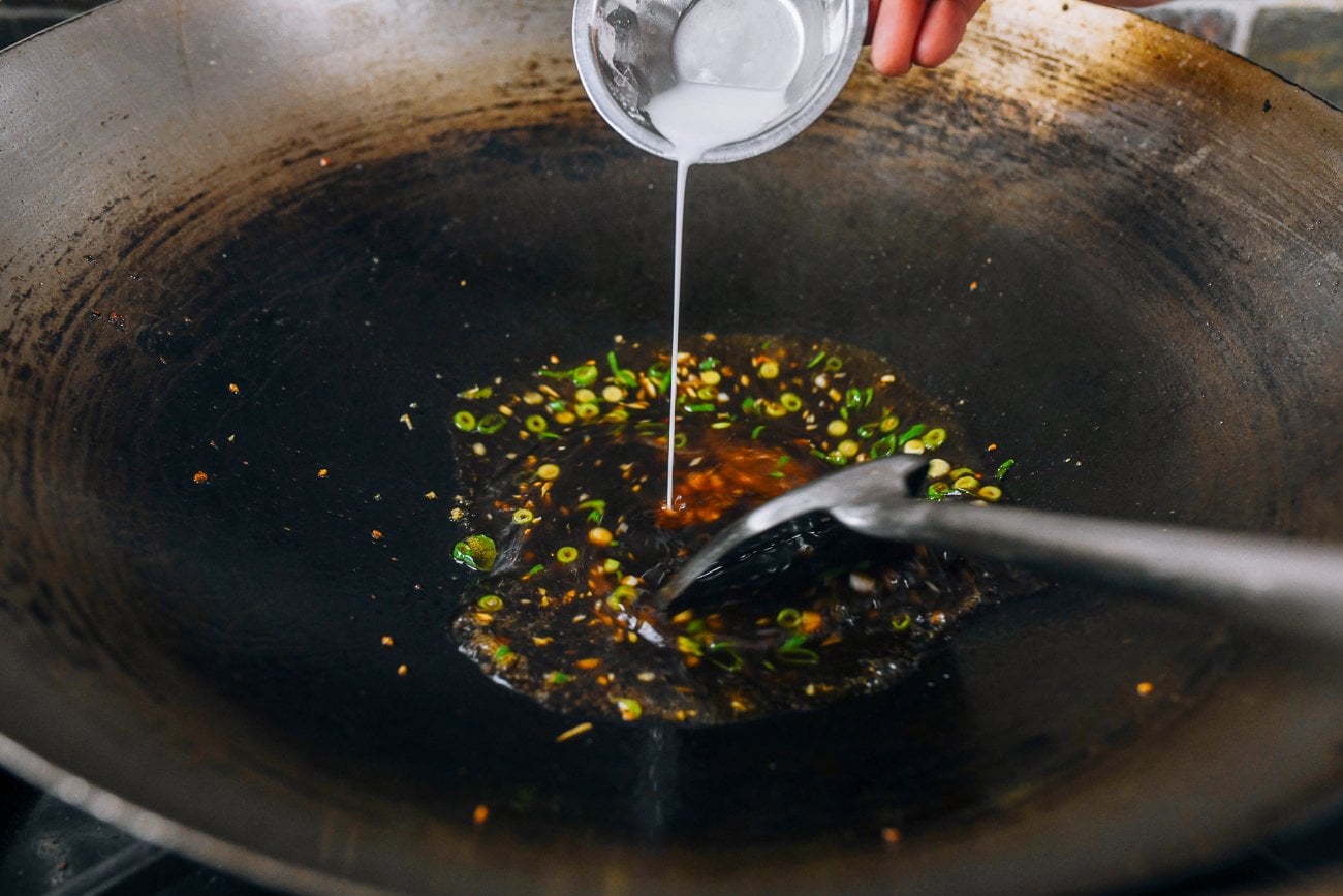 drizzling cornstarch slurry into sauce