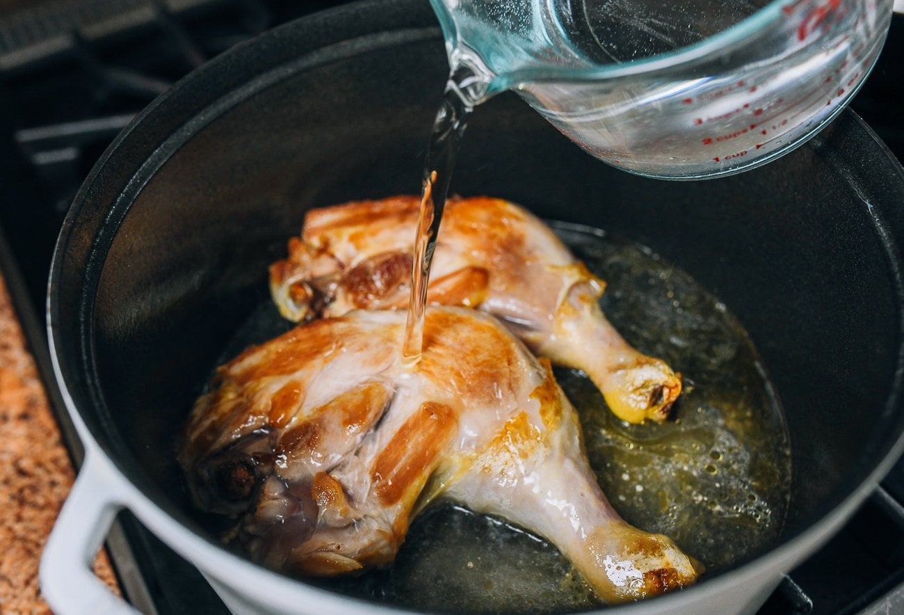 adding water to chicken leg quarters