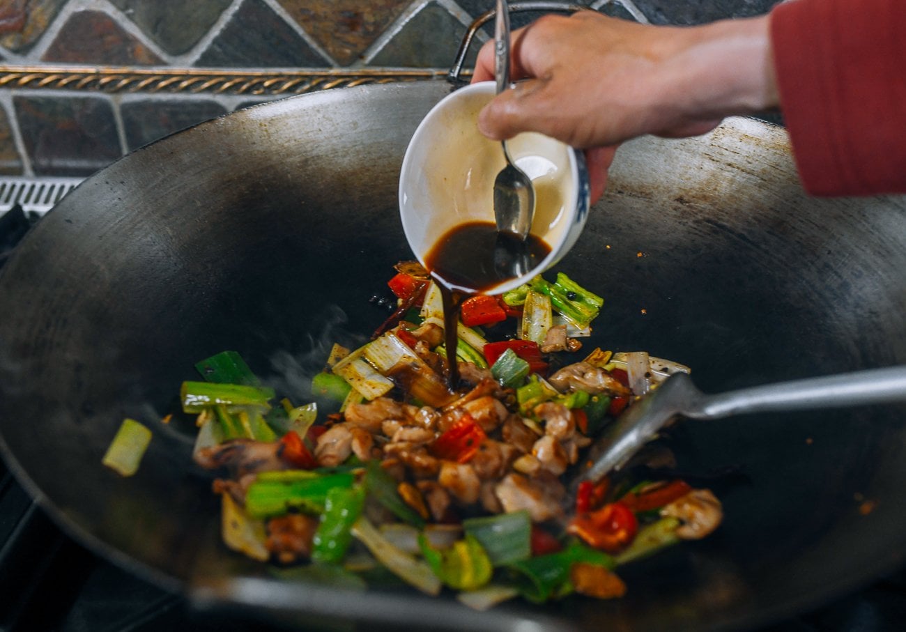 adding sauce mixture to chicken and peppers