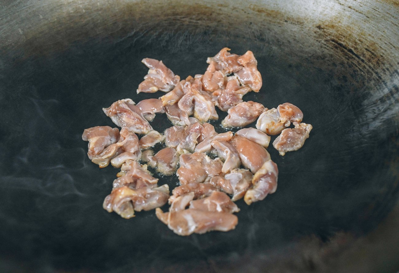 chicken pieces in wok in one layer