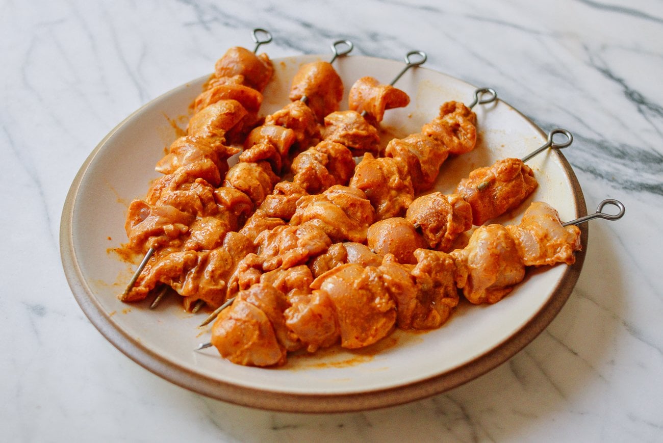 chicken pieces on metal skewers