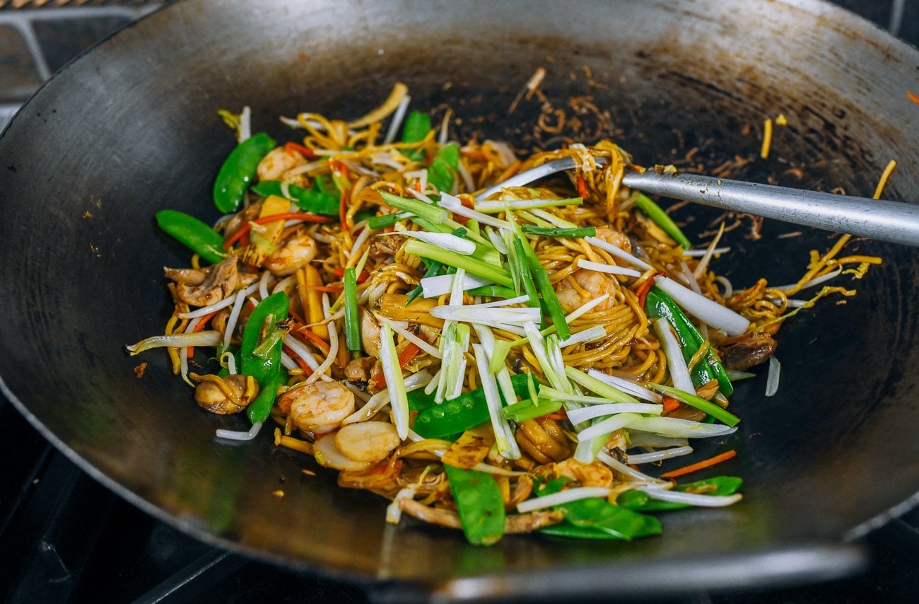 scallions added to lo mein in wok