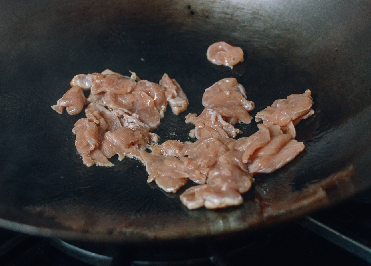 searing chicken in wok