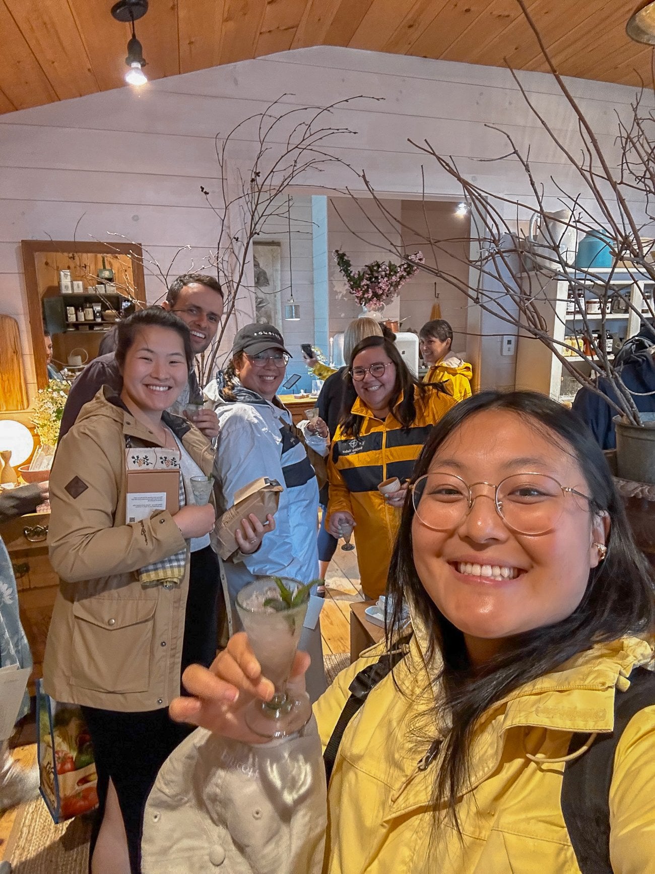 Sarah, Kaitlin, Justin, and cousins sipping welcome drinks in The Lost Kitchen shop with homewares