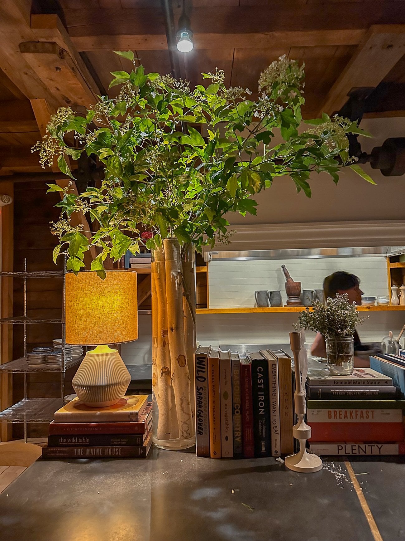 Birch logs and foliage in a vase at The Lost Kitchen