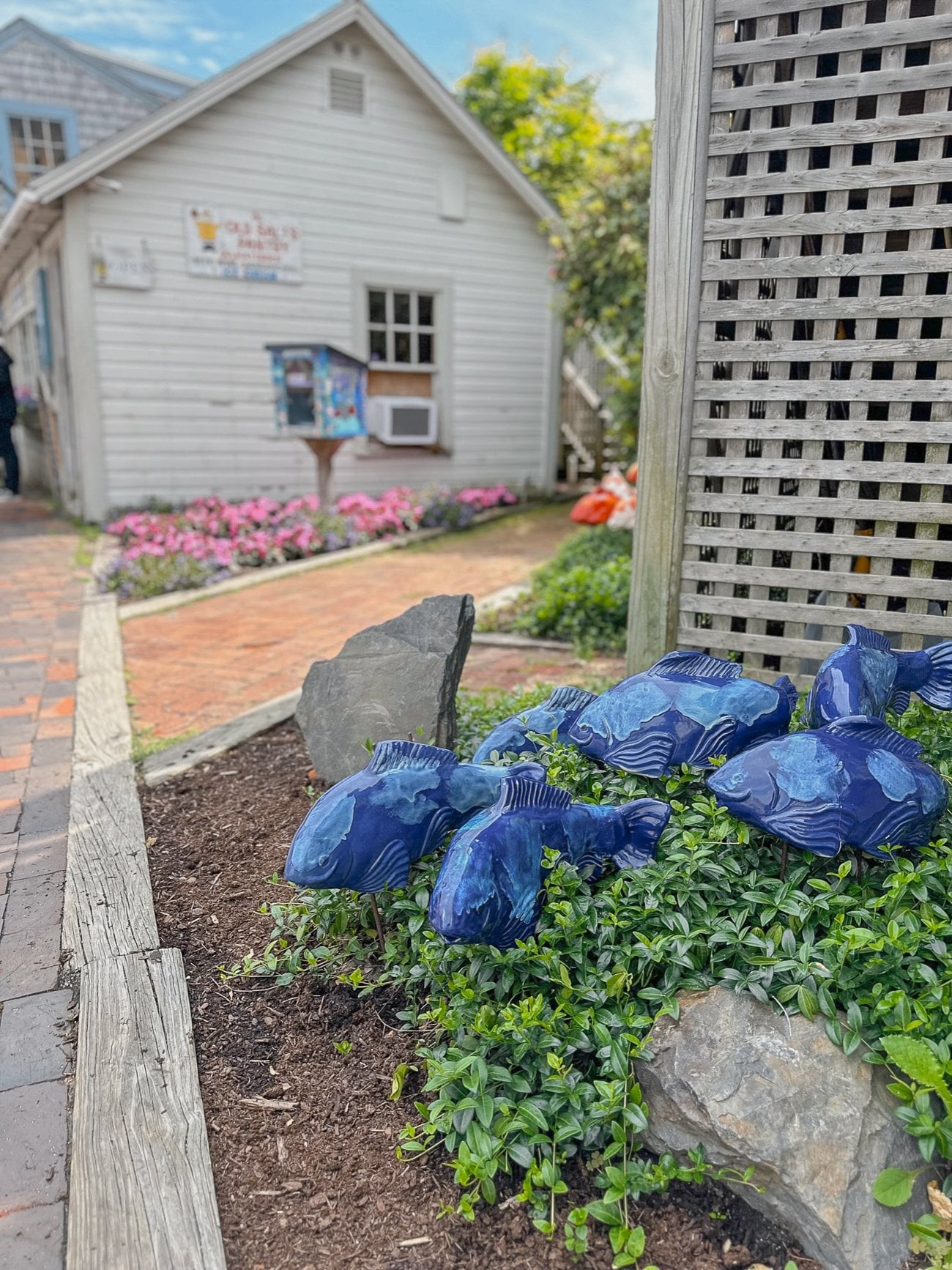 Blue ceramic fish in a garden