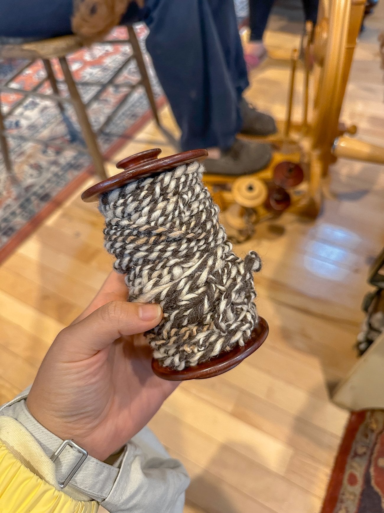 spool of twisted brown and white yarn