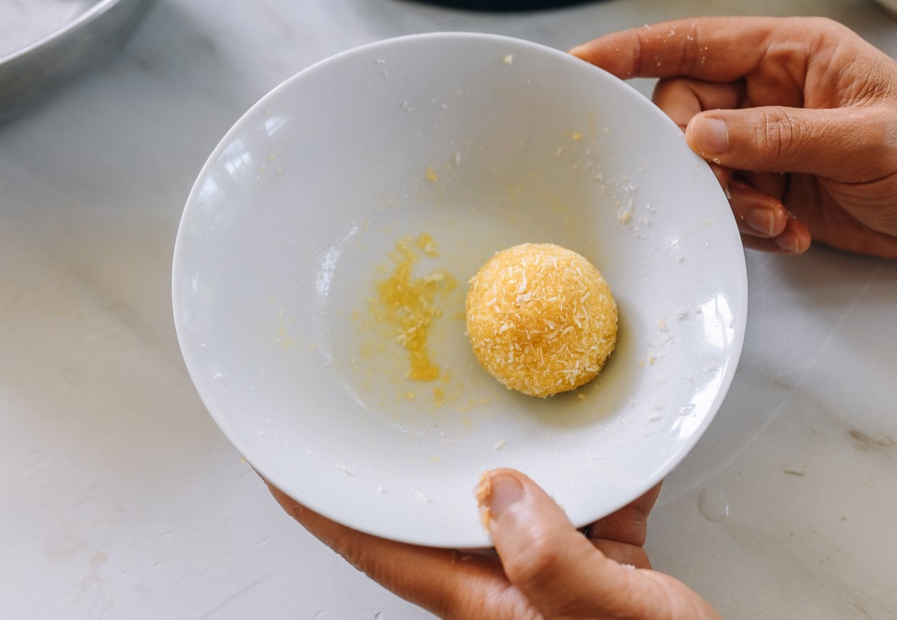 rolling coated tang yuan in a bowl to smooth the other coating