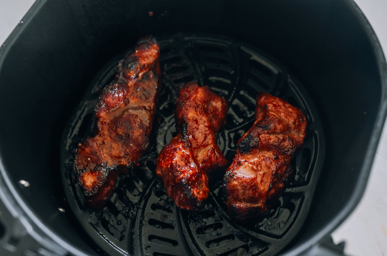 char siu pieces in air fryer basket