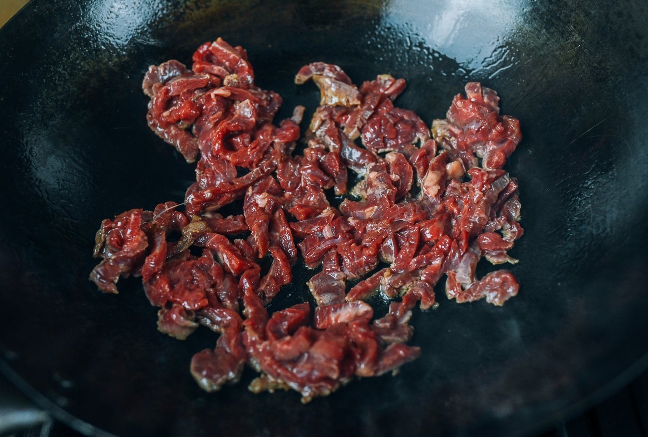 searing beef in wok