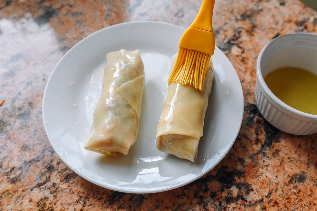 brushing egg rolls with oil