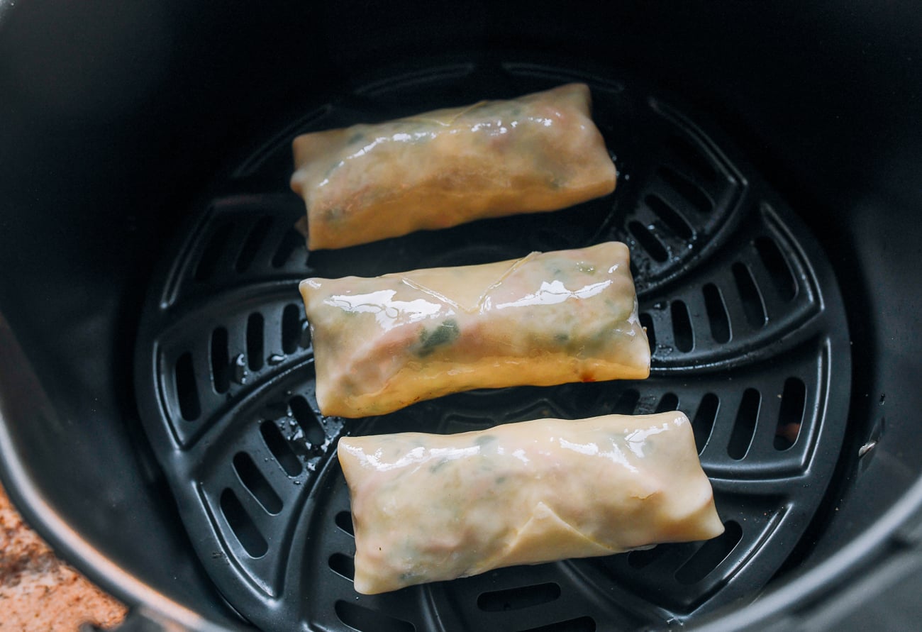 oiled egg rolls in air fryer basket