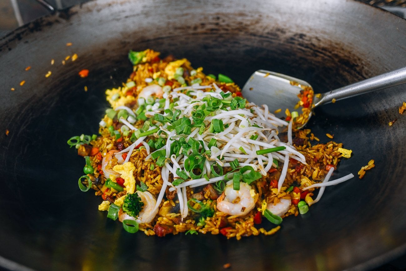 adding scallion and bean sprout to fried rice