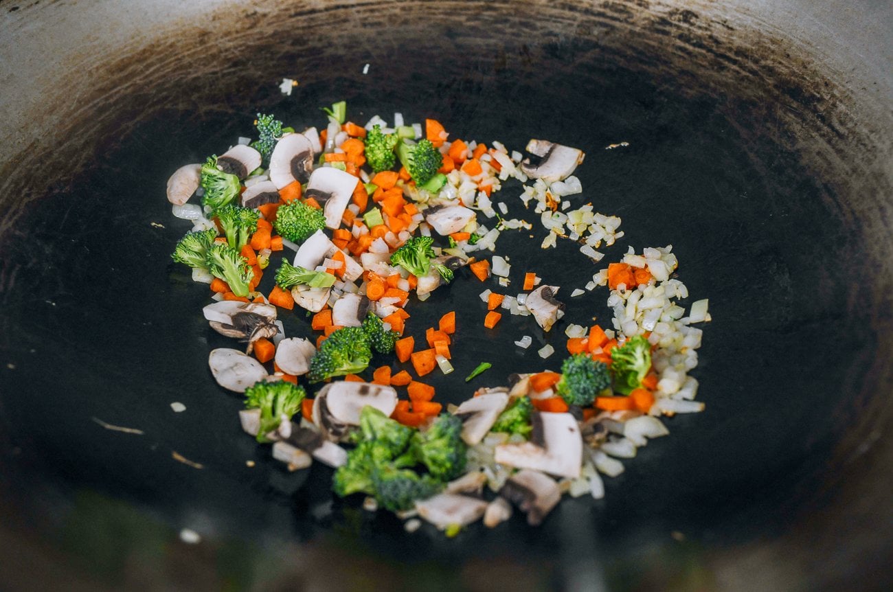 cooking onions and harder to cook vegetables in wok