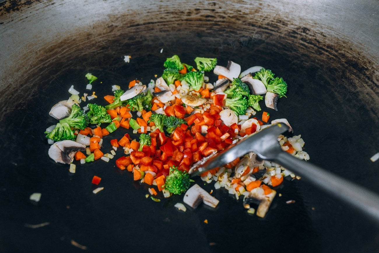 onions, carrots, broccoli, mushrooms, red bell pepper in wok
