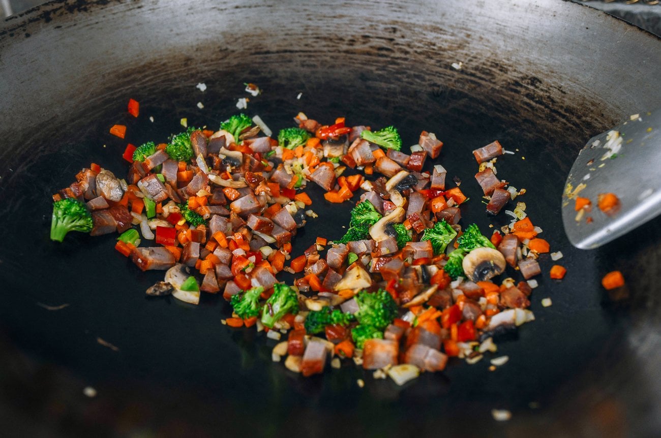 cubed char siu in wok with vegetables