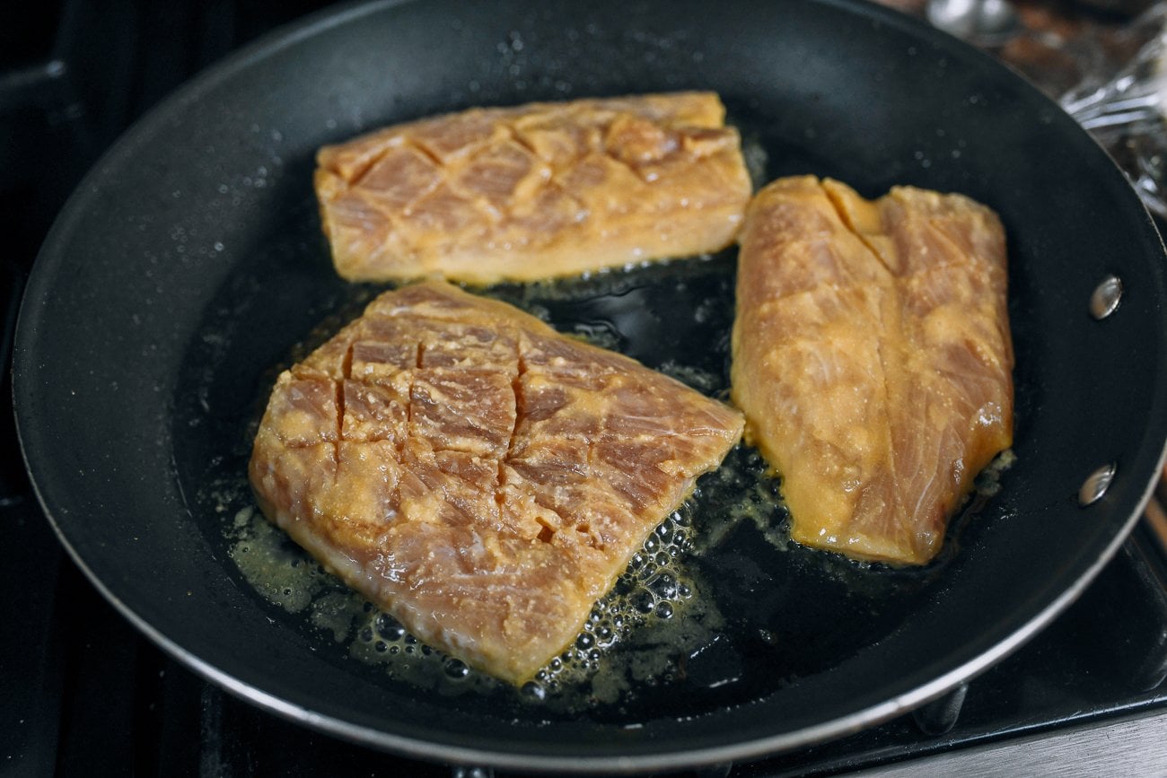 mahi mahi filets marinated with miso in frying pan