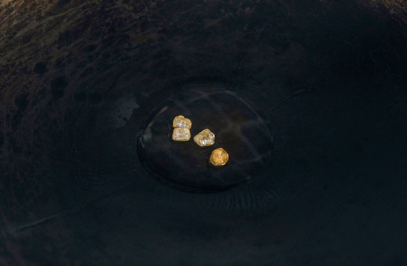 lumps of rock sugar in oil in wok