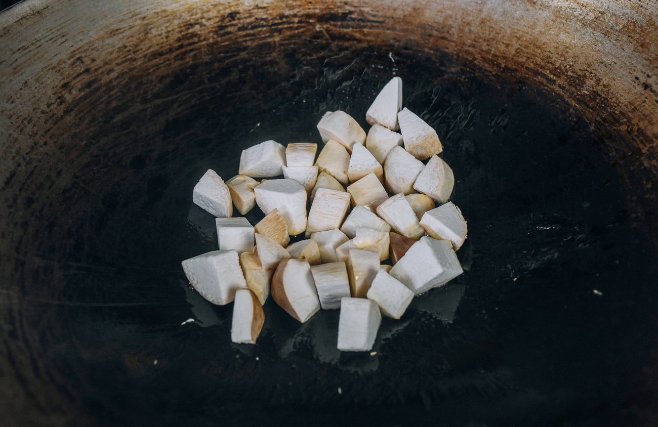 adding king mushrooms to wok
