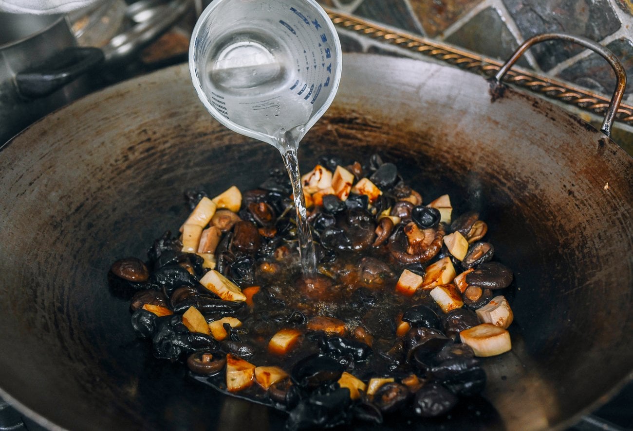 Adding water to mushroom mixture