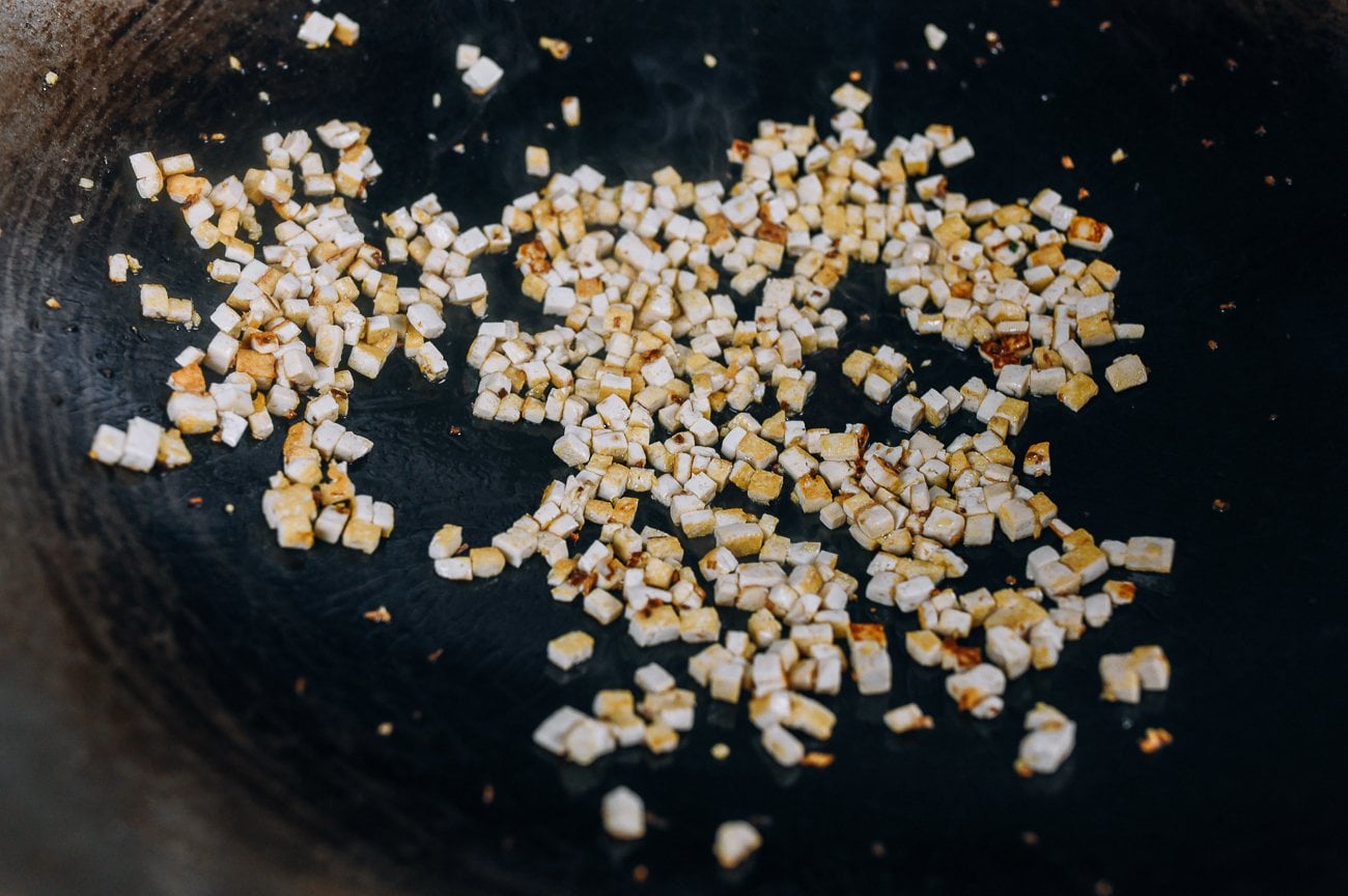 browned bits of finely diced tofu in wok