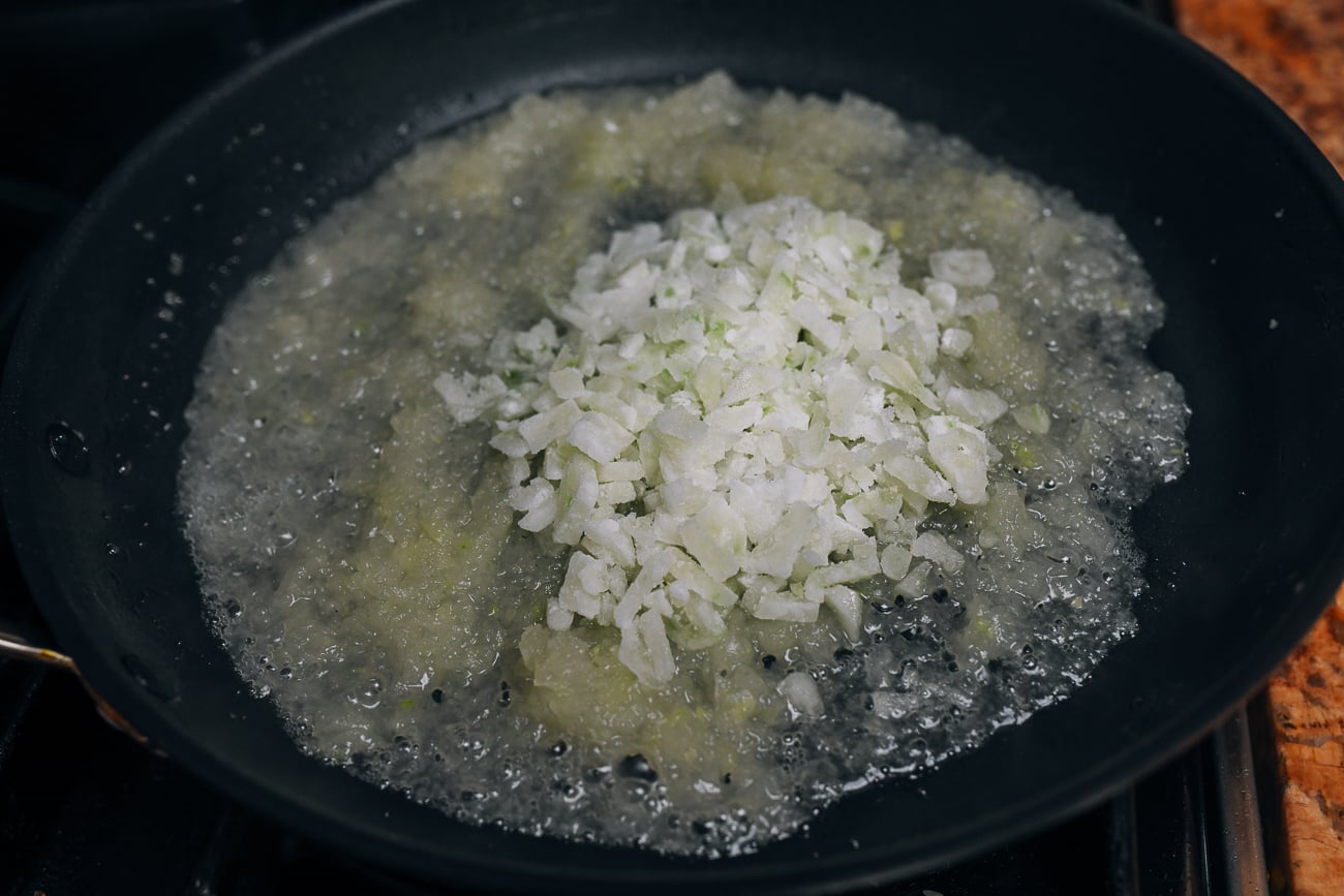 adding winter melon candy to winter melon in pan