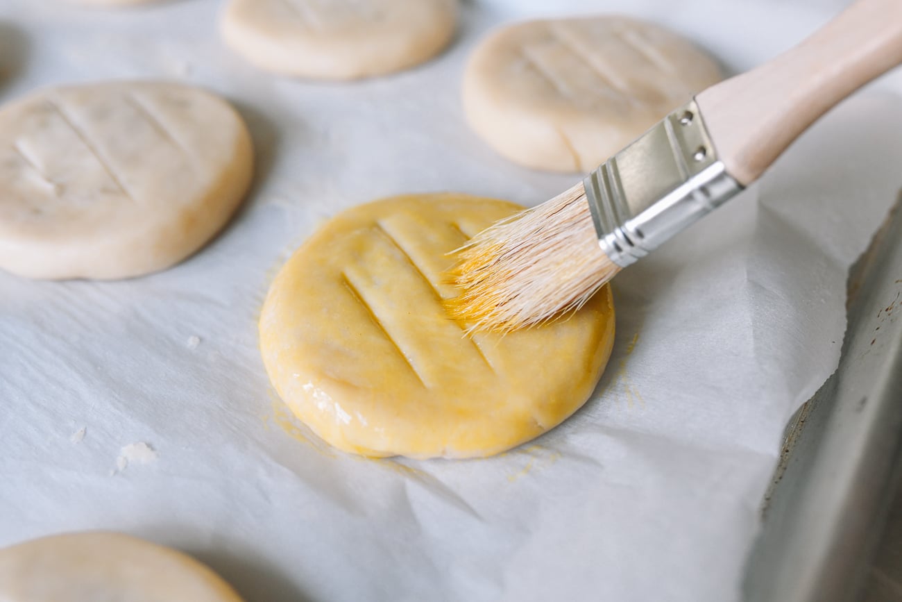 brushing wife cake with egg wash before baking