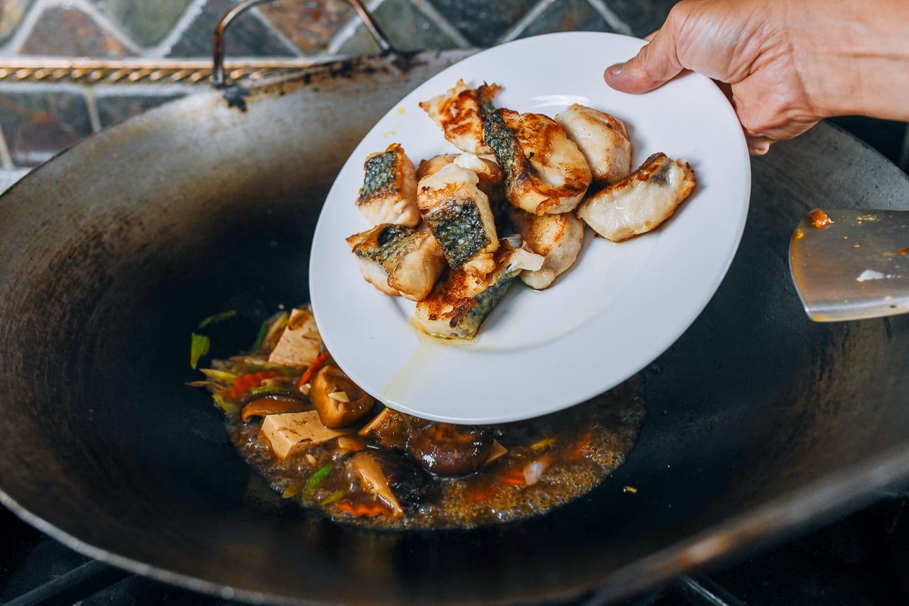 adding fish back to wok