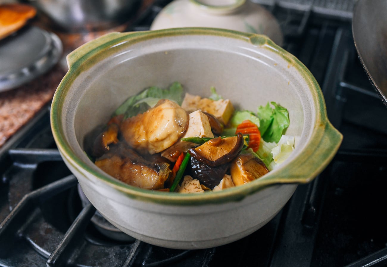 Adding fish mixture to clay pot