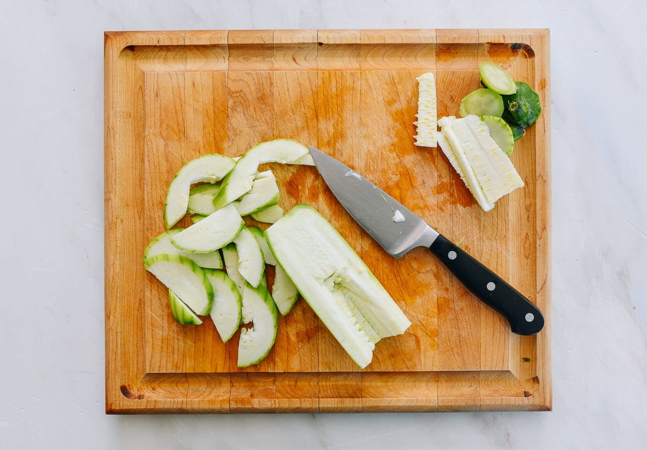 slicing peeled loofah with seeds removed