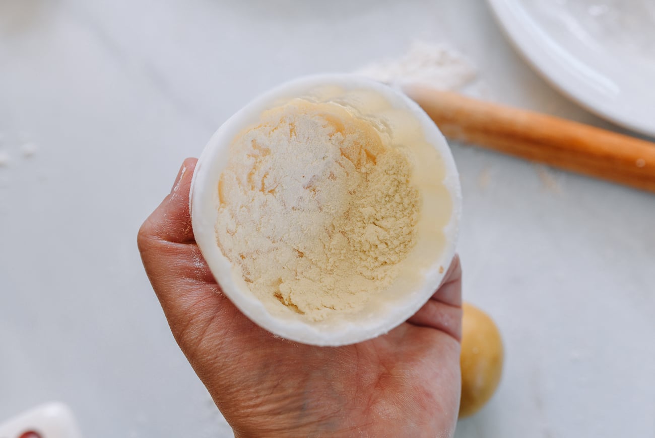 flouring inside of mooncake mold