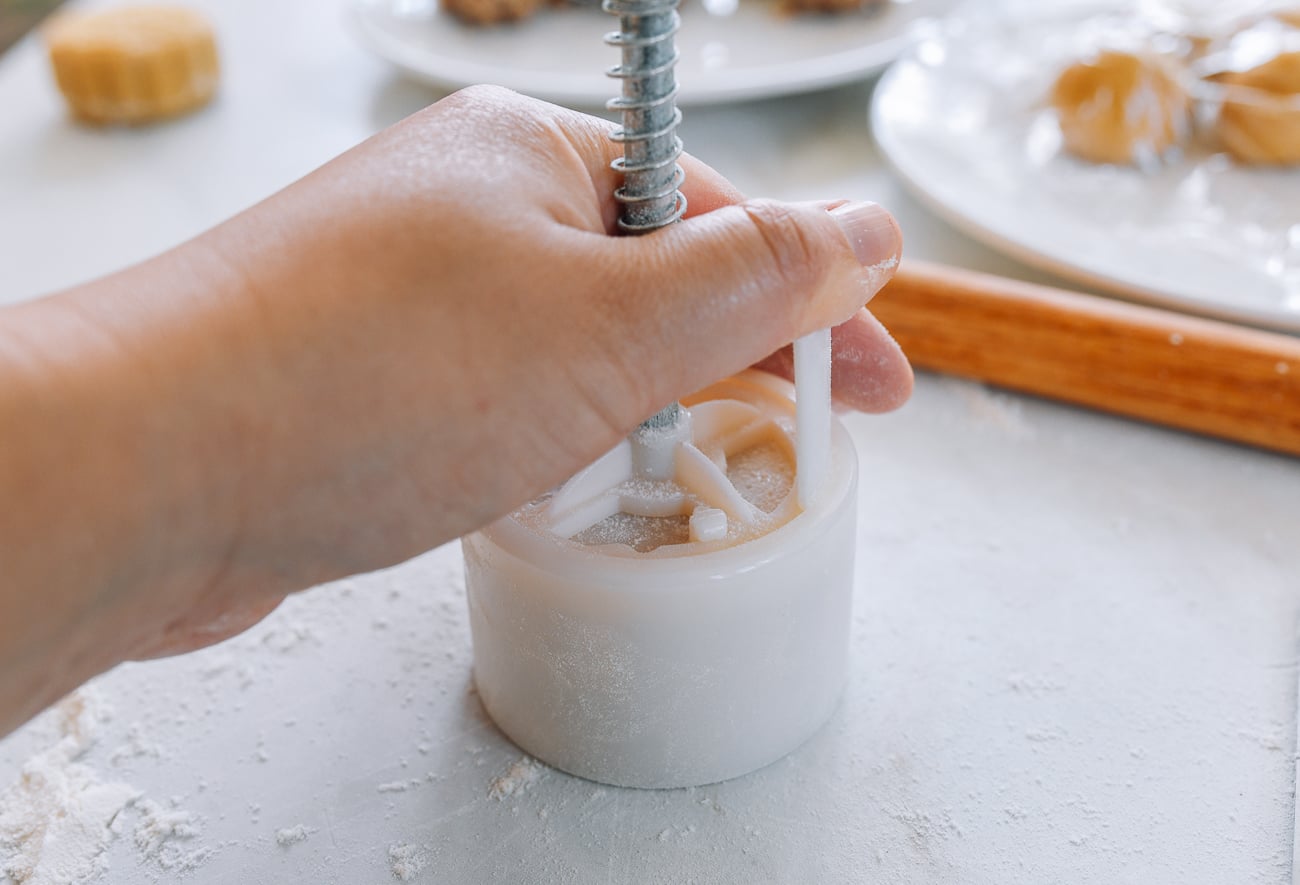 pressing mooncake mold to work surface