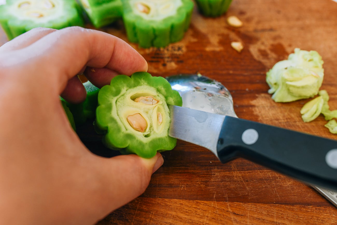 removing seeds from bitter melon with paring knife