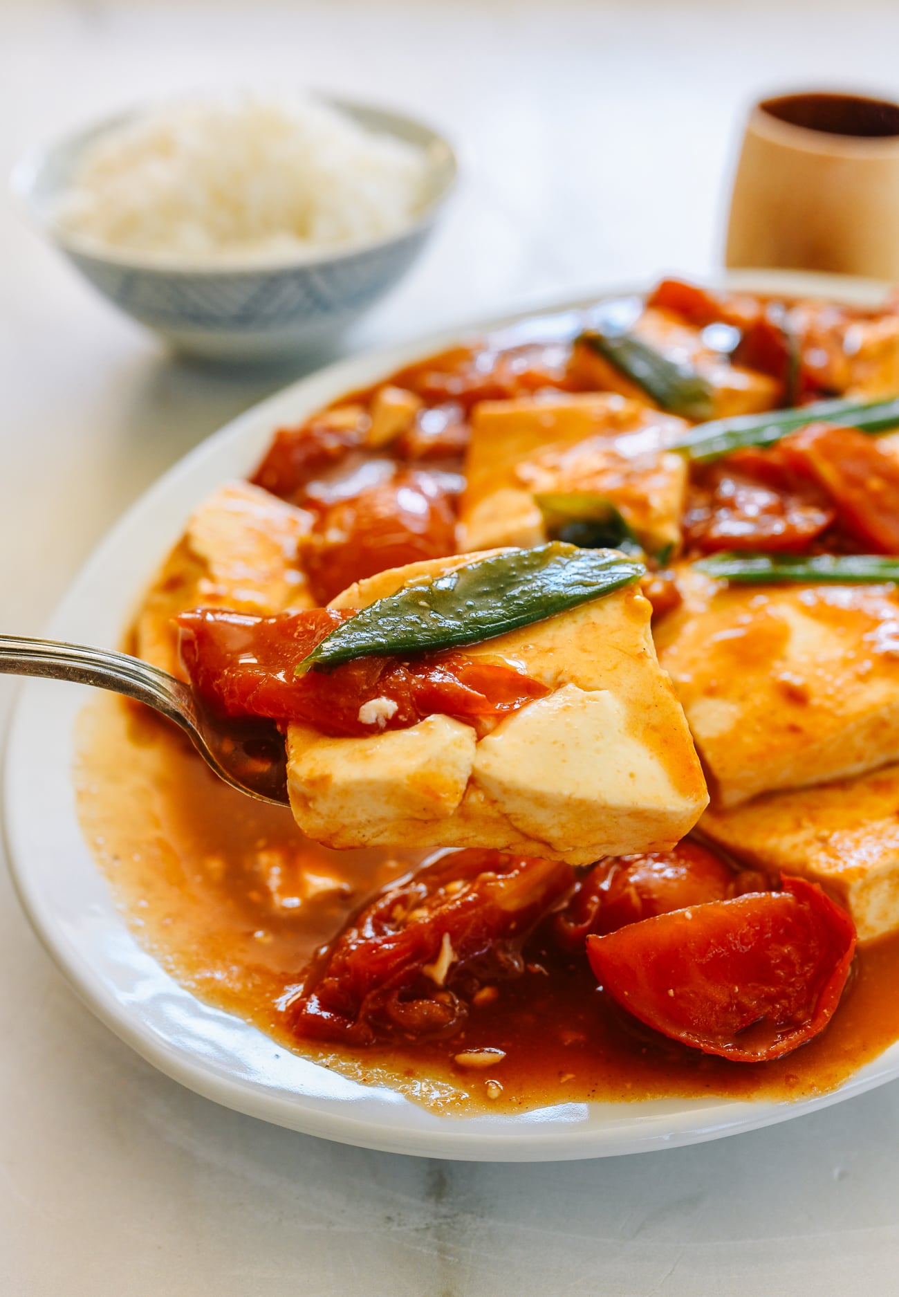 scooping tomato tofu onto spoon
