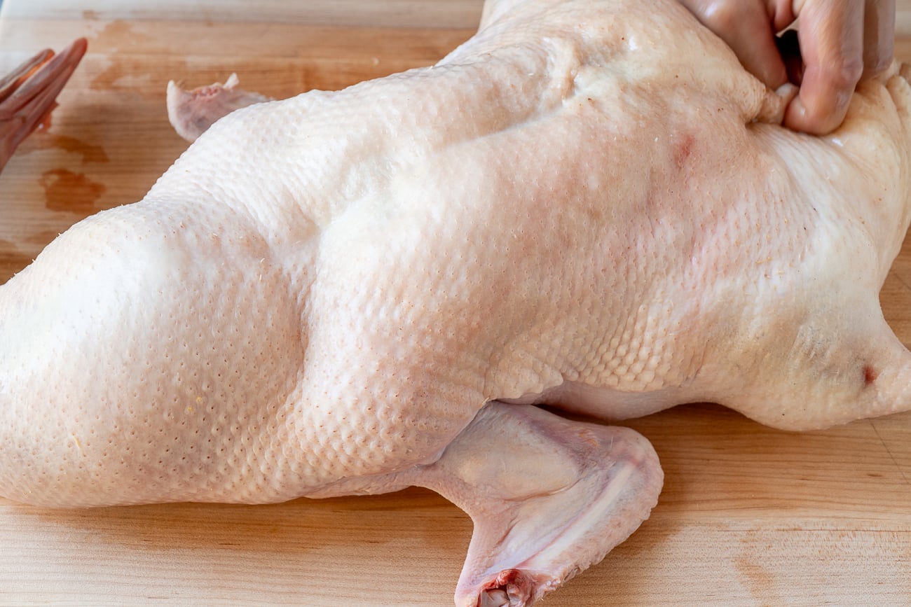 inflating duck with air pump before roasting