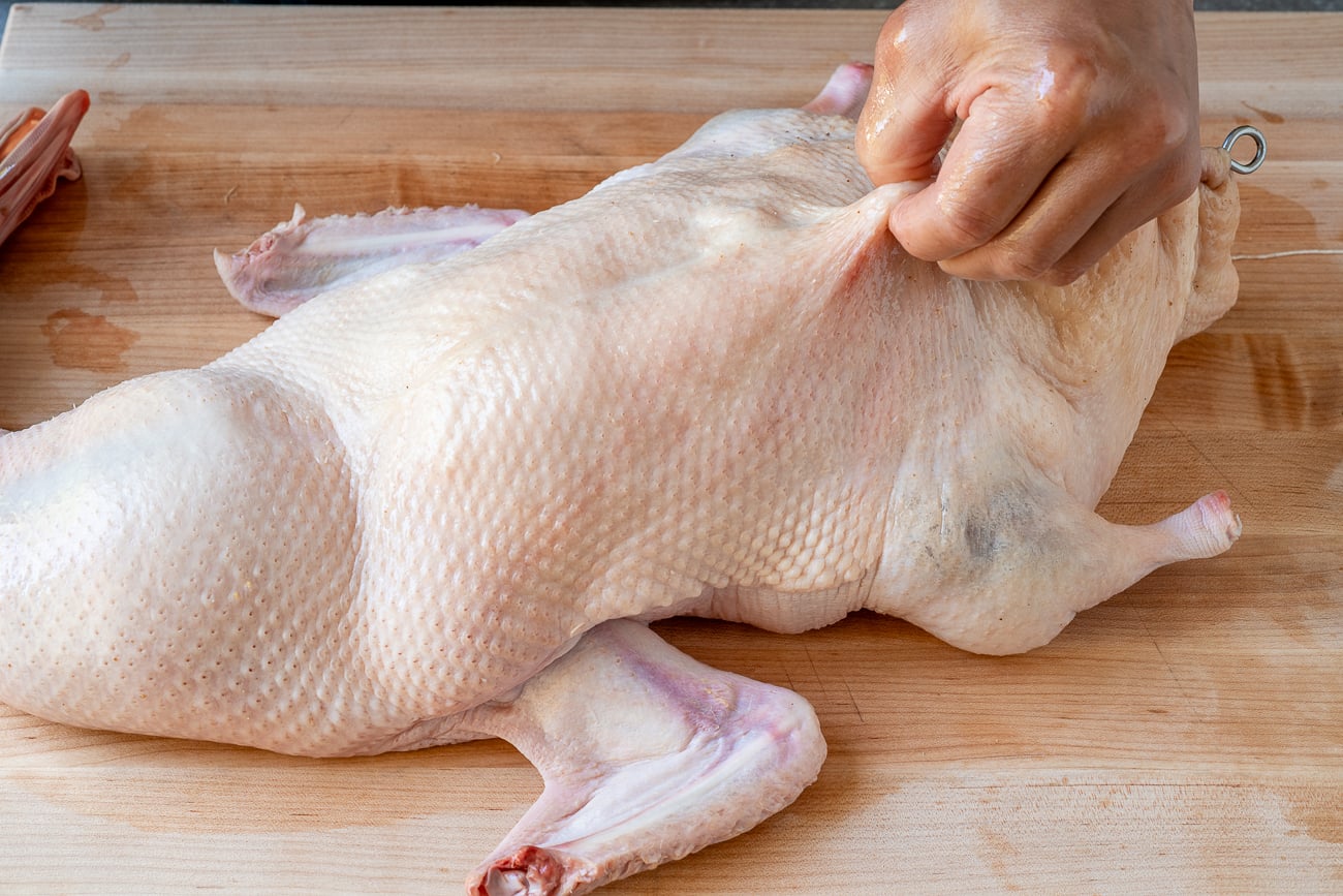 pulling duck skin up with fingers