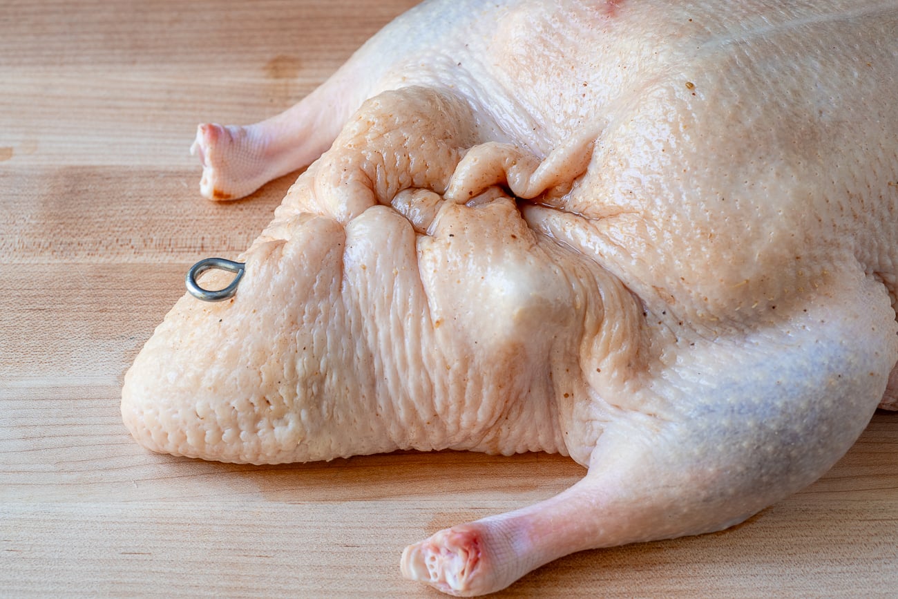 sealed duck cavity with metal skewer to make Chinese roast duck